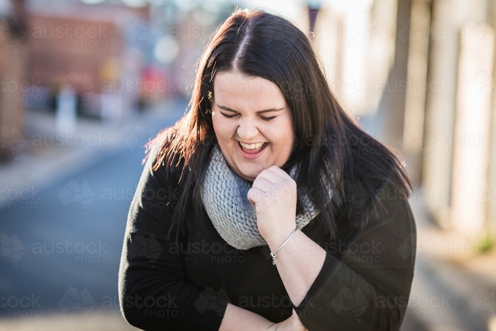 Woman with long hair laughing hard - Australian Stock Image