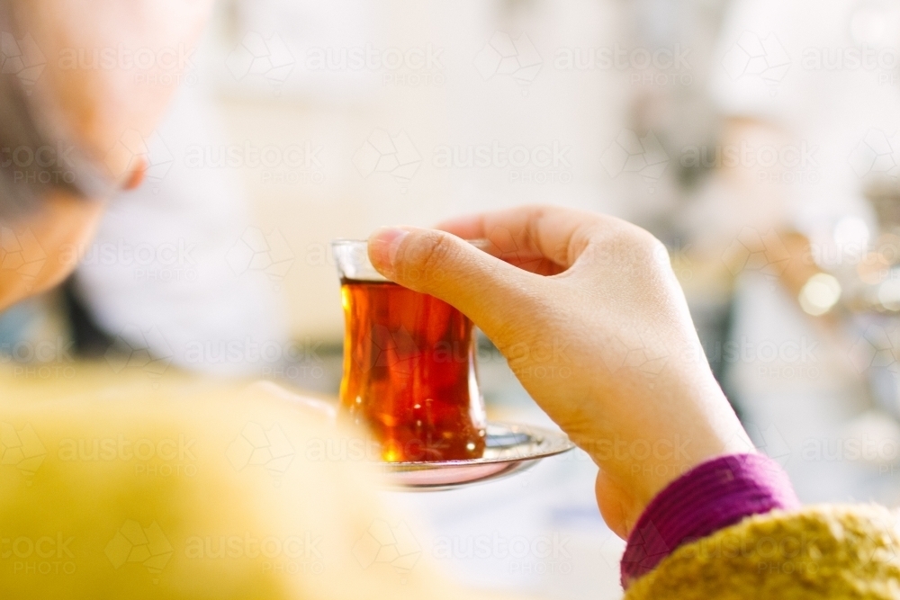 Women drinking turkish tea at markets - Australian Stock Image