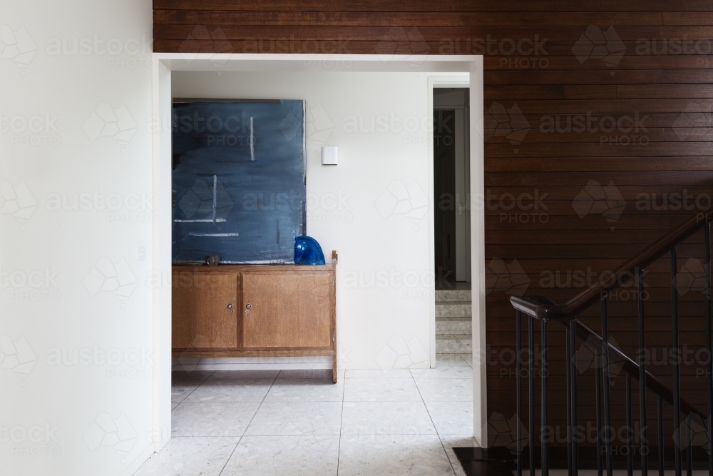 Wood panel wall detail and entry foyer in mid century modern home - Australian Stock Image
