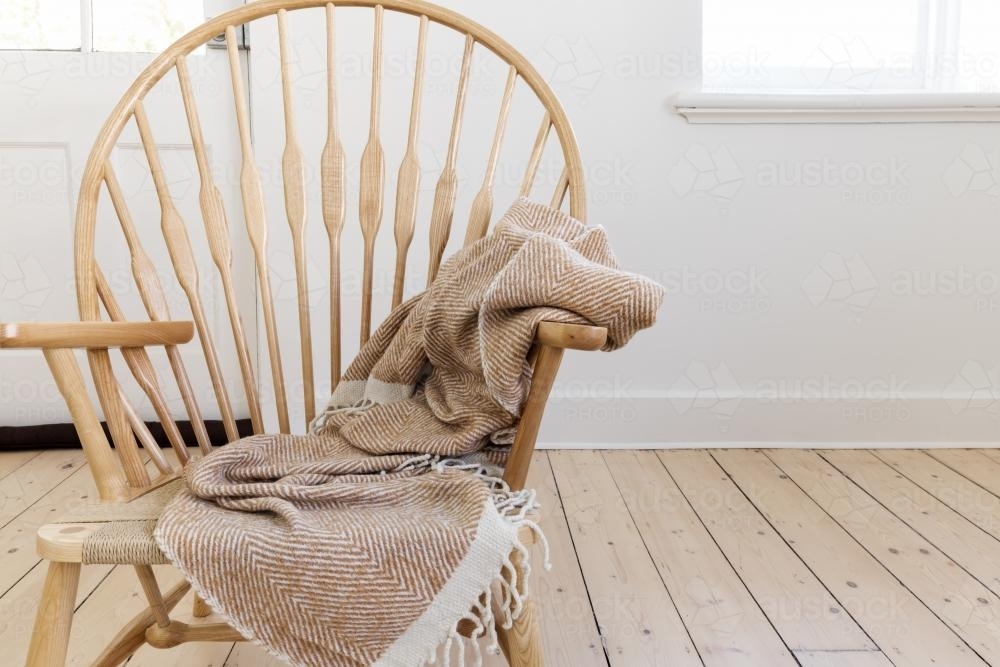 Wooden country style chair with textured throw blanket and negative space for text - Australian Stock Image