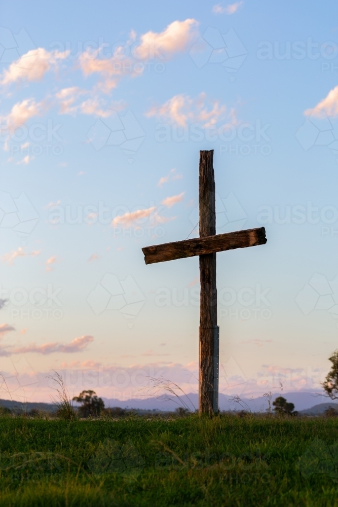 Wooden cross shape structure in farm paddock on good Friday for Easter - Australian Stock Image