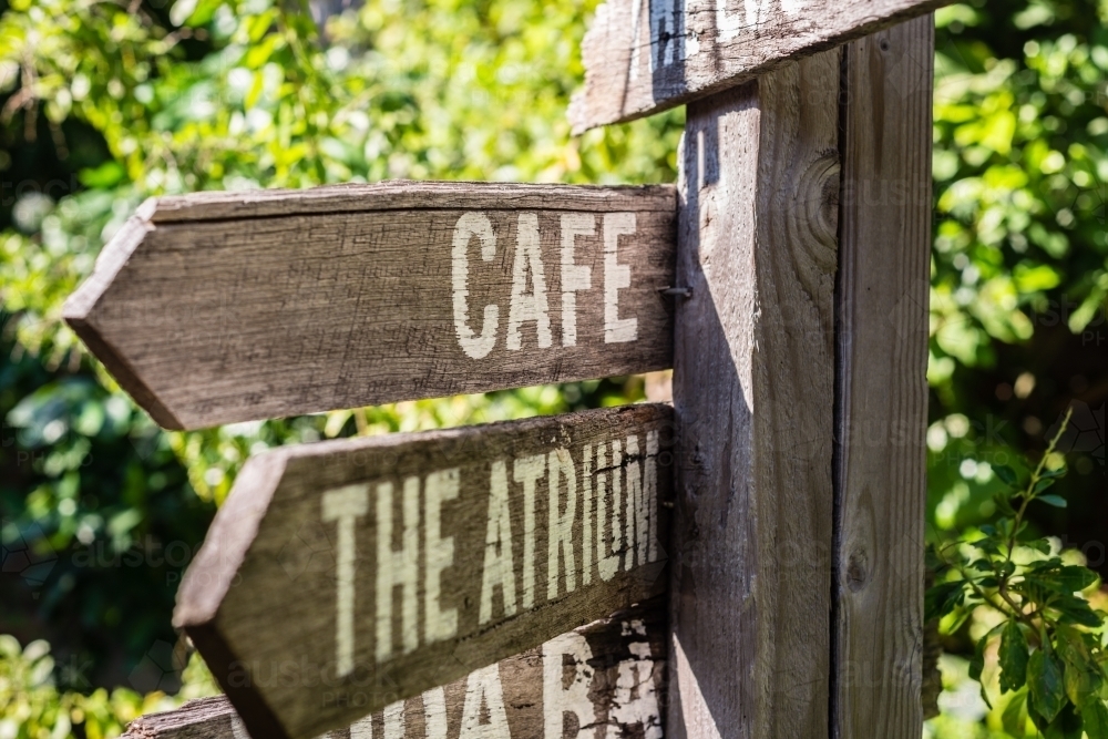 wooden direction sign in a farmers market - Australian Stock Image