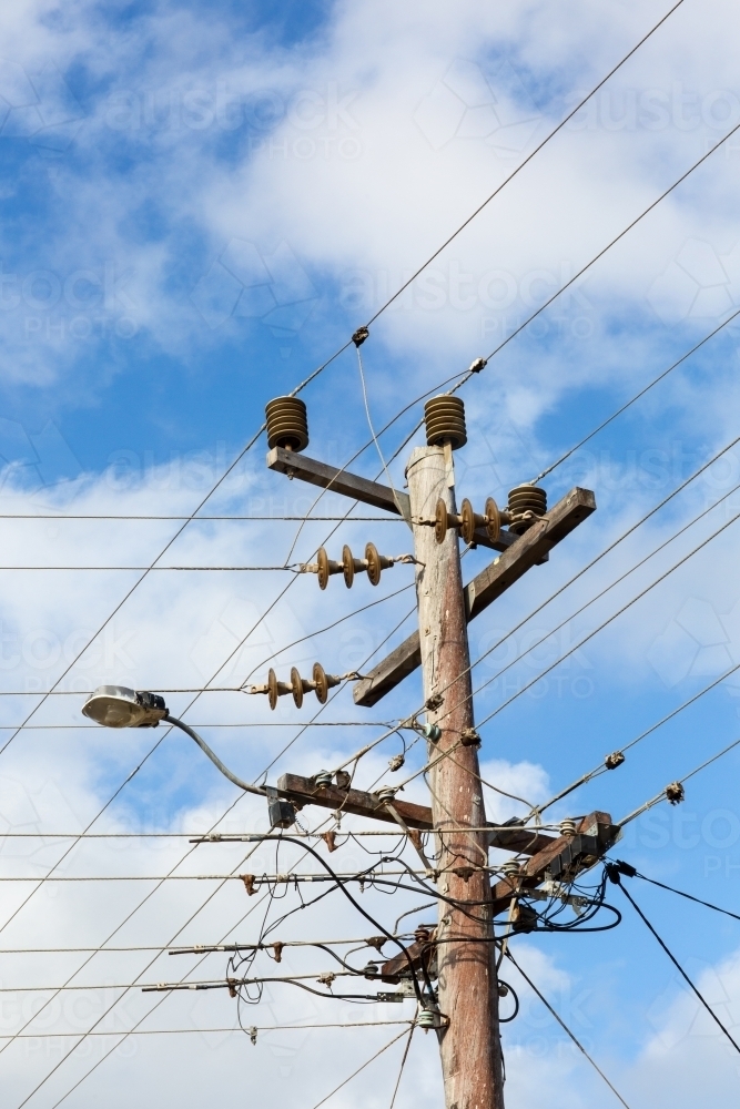Image of Wooden electricity pole with wires and insulators Austockphoto