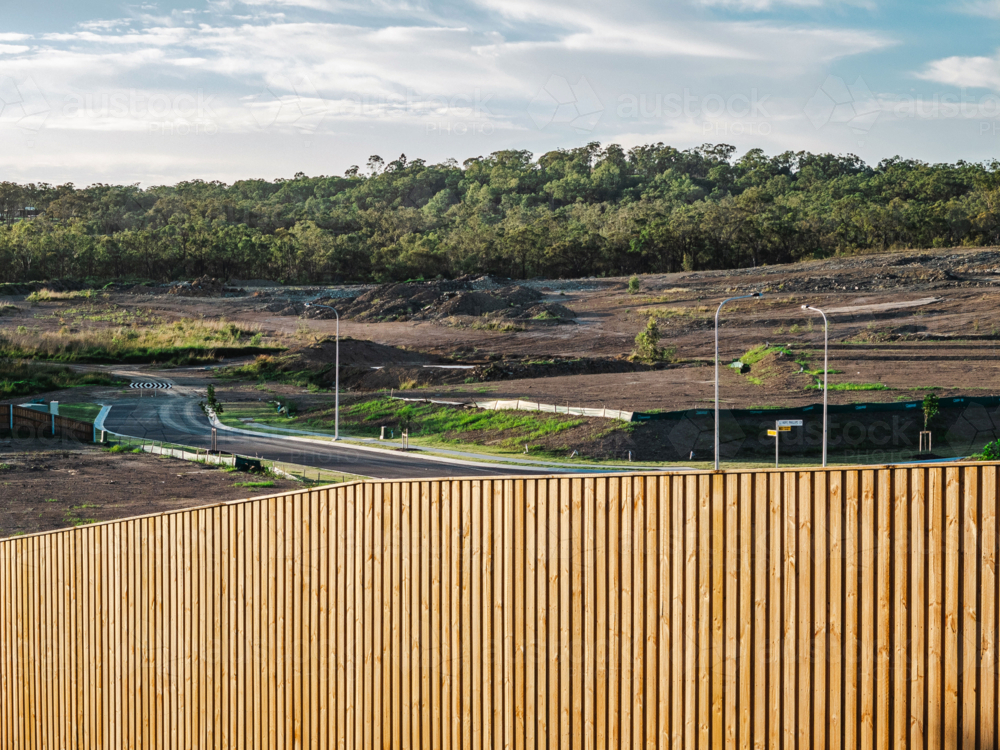 Wooden fence in front of unfinished residential development - Australian Stock Image