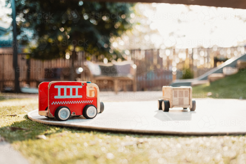 Wooden firetruck toy in golden morning light - Australian Stock Image