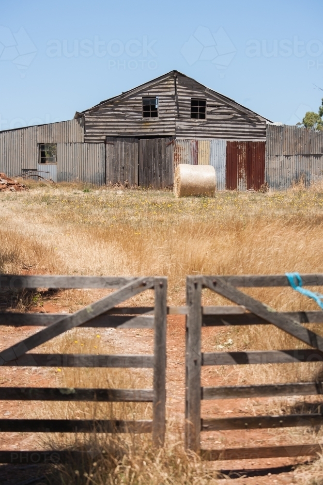 wooden gate and track leading to an oid barn - Australian Stock Image