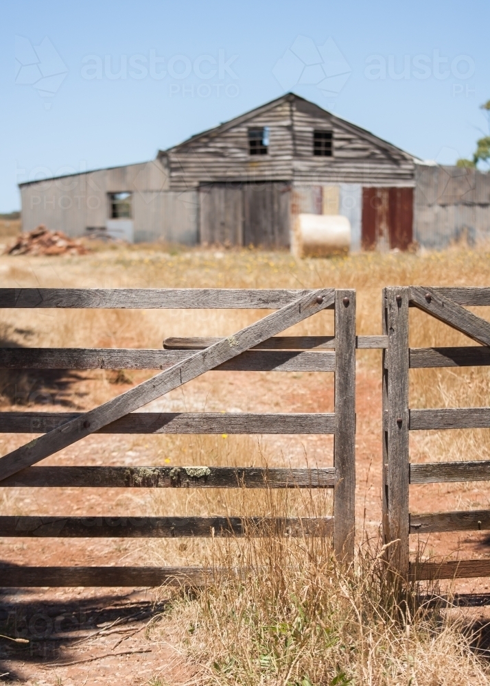wooden gate and track leading to an old barn - Australian Stock Image