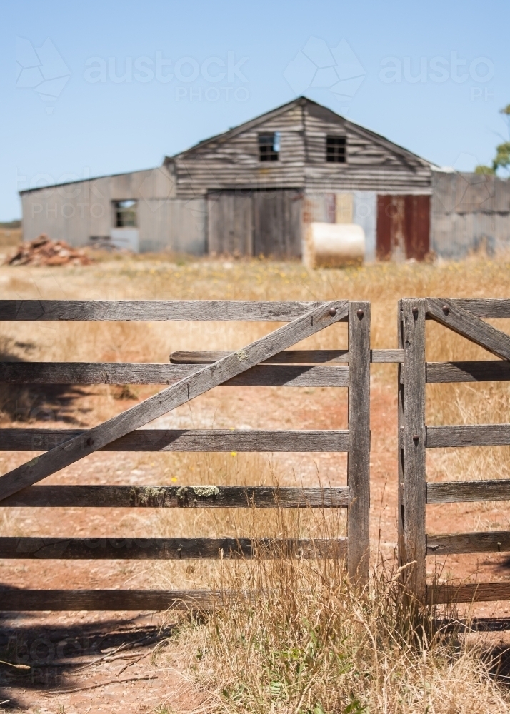 wooden gate and track leading to an old barn - Australian Stock Image