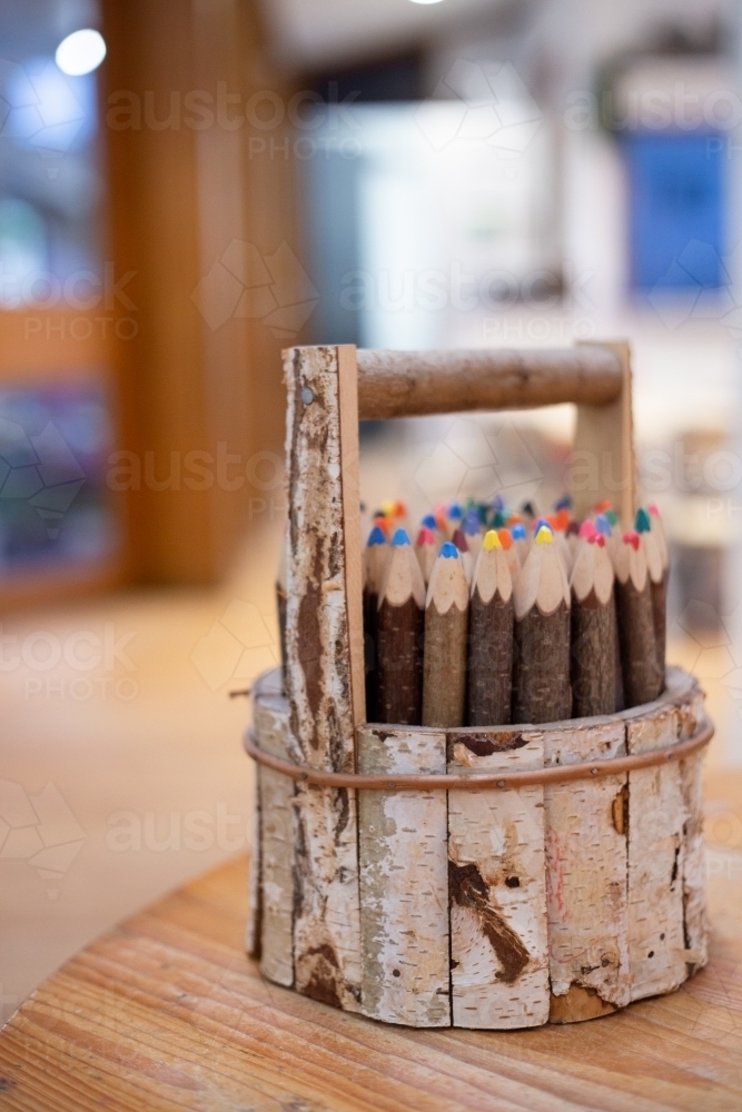 Wooden pencil holder with coloured pencils - Australian Stock Image