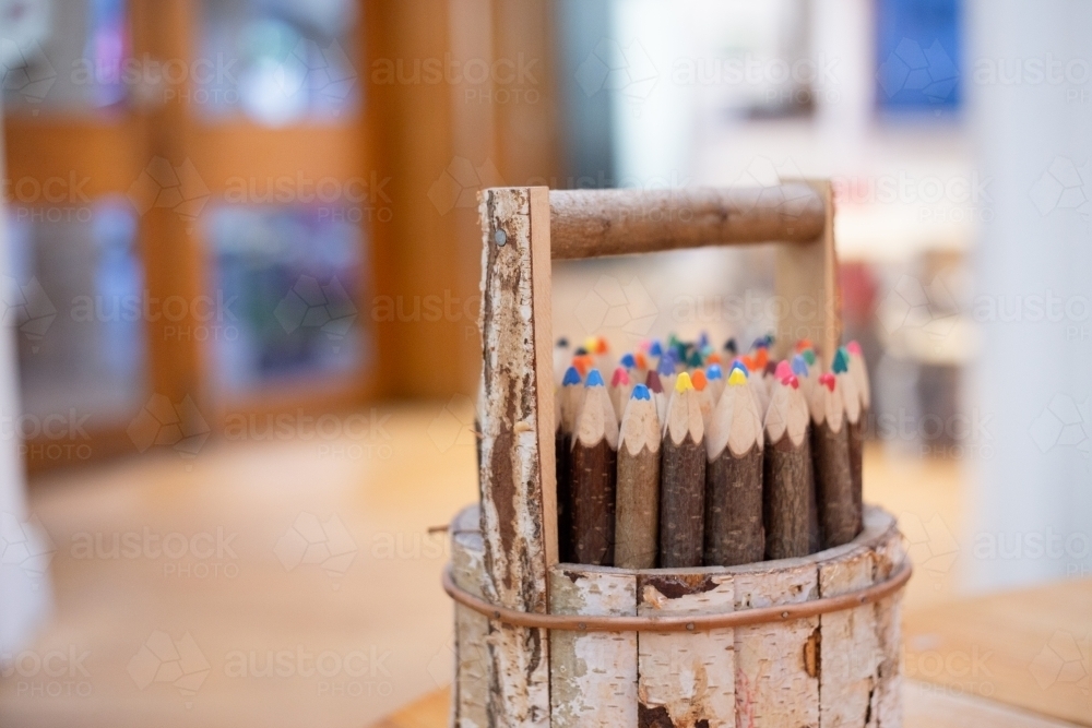 Wooden pencil holder with coloured pencils - Australian Stock Image
