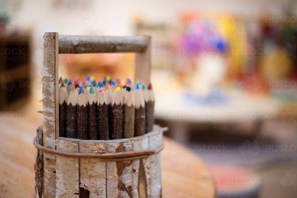 Wooden pencil holder with coloured pencils - Australian Stock Image