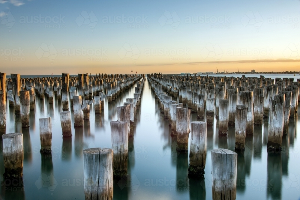 Wooden posts left behind in water at pier at Port Melbourne - Australian Stock Image