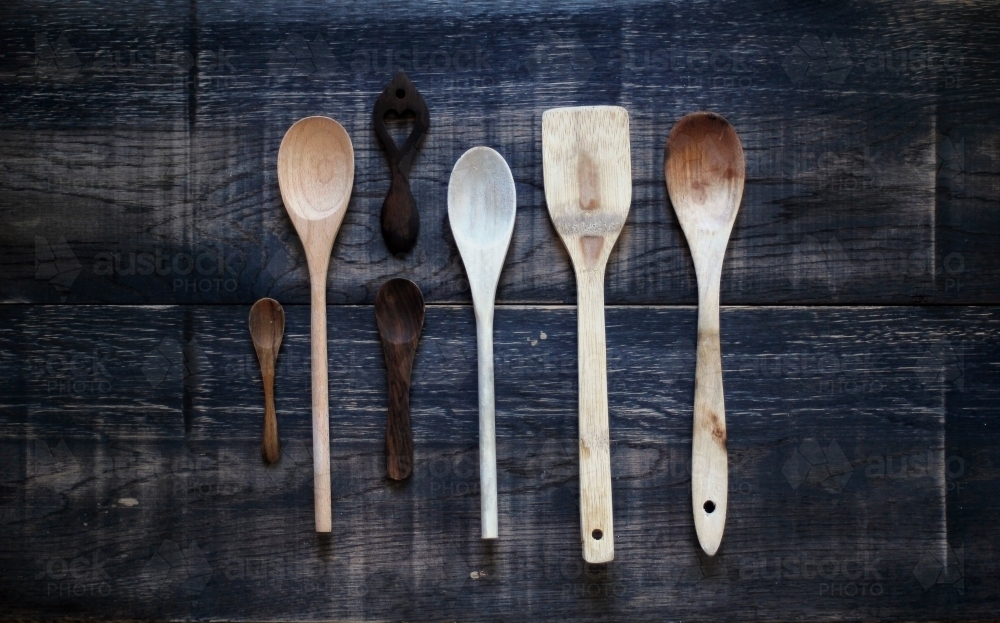 Wooden spoons on dark background - Australian Stock Image