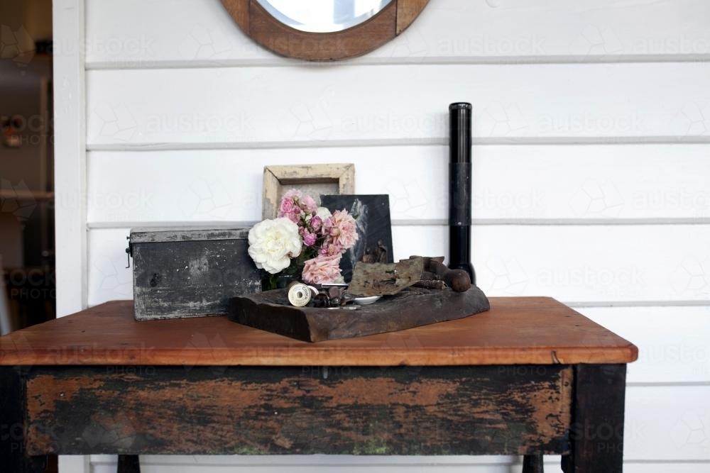 Wooden table with roses and vintage decorations - Australian Stock Image