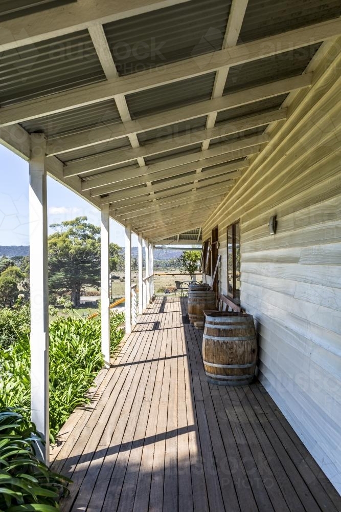 Wooden verandah with wine barrells, corrugated tin roof and weatherboards - Australian Stock Image