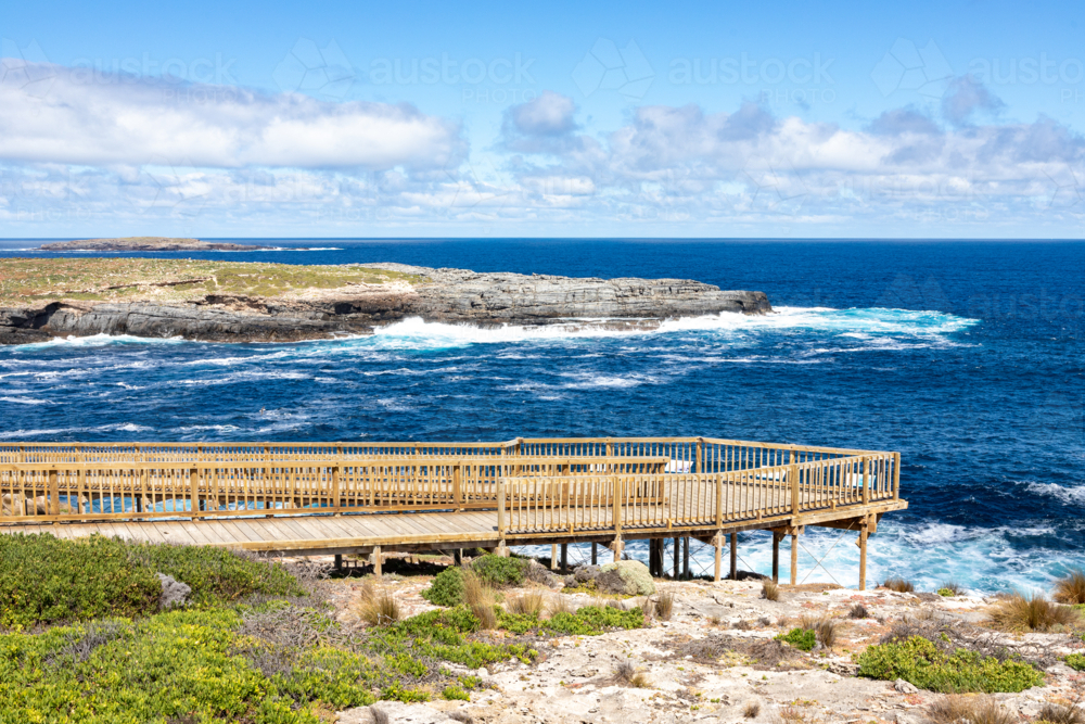 Wooden Viewing Platform at Admirals Arch Overlooking Crashing Waves and Rocky Coastline - Australian Stock Image