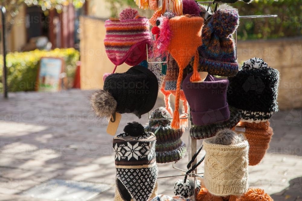 Woolen winter hats for sale on a hat stand - Australian Stock Image