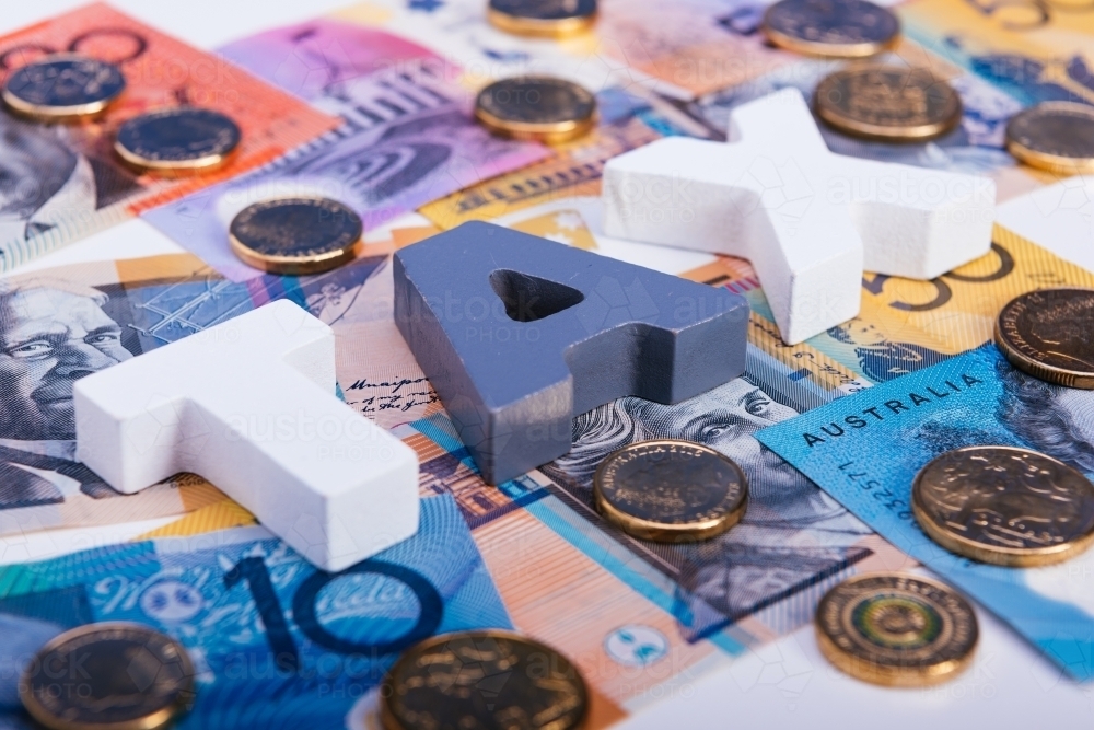 Word TAX on Australian currency background. - Australian Stock Image