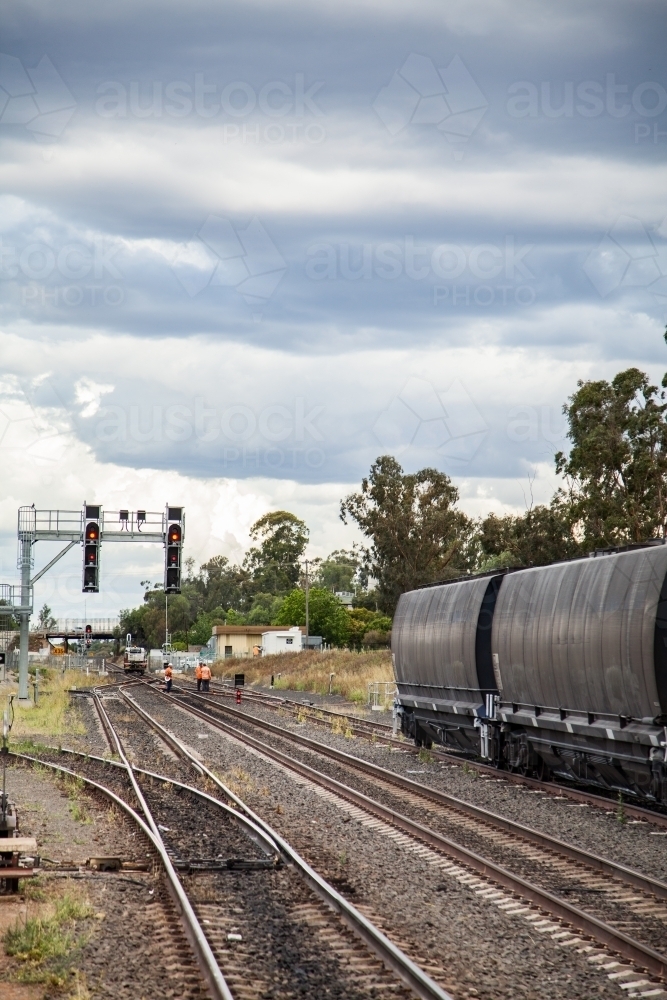 Workers doing train track repairs on overcast day - Australian Stock Image