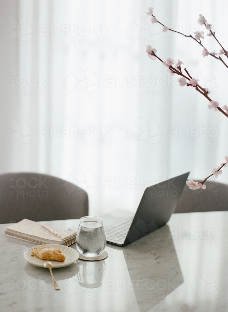 Working from home on a dining table - Australian Stock Image
