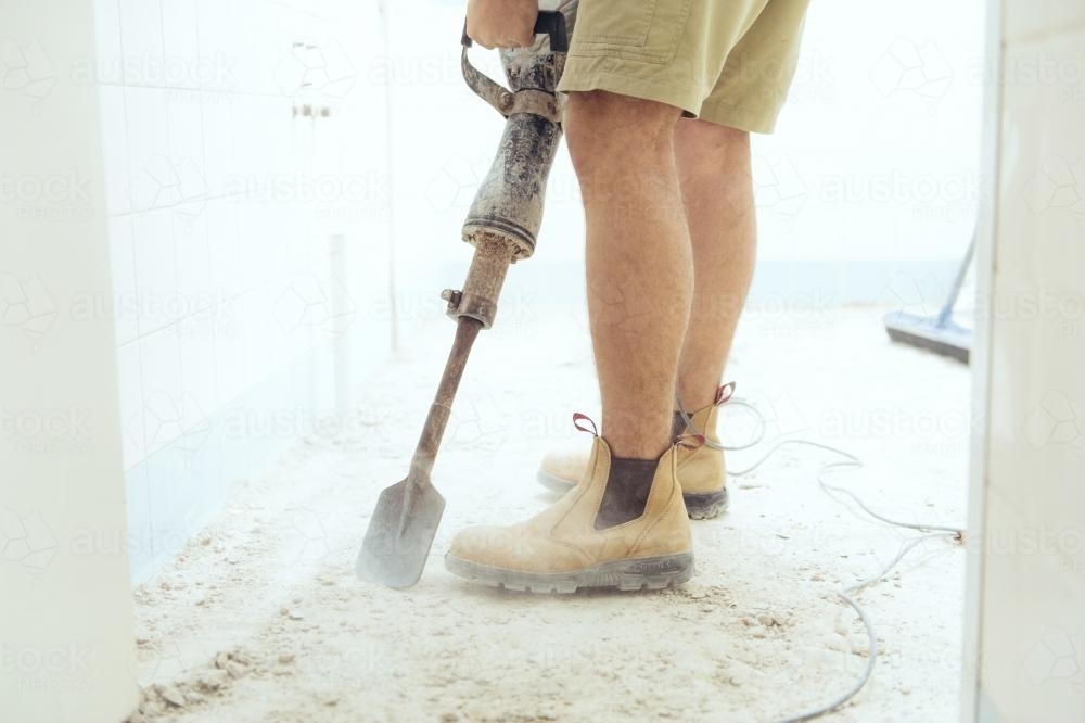 Workman jackhammering on construction site - Australian Stock Image