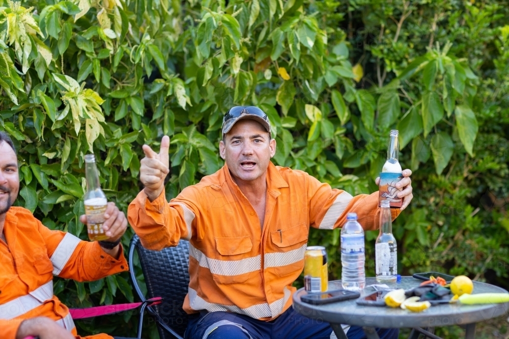 workmates having a drink after work in the backyard - Australian Stock Image