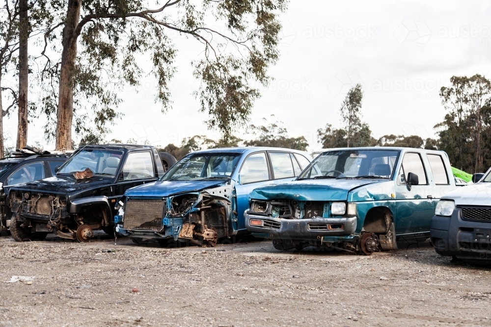 Wrecked and smashed cars parked in car wreckers junkyard - Australian Stock Image