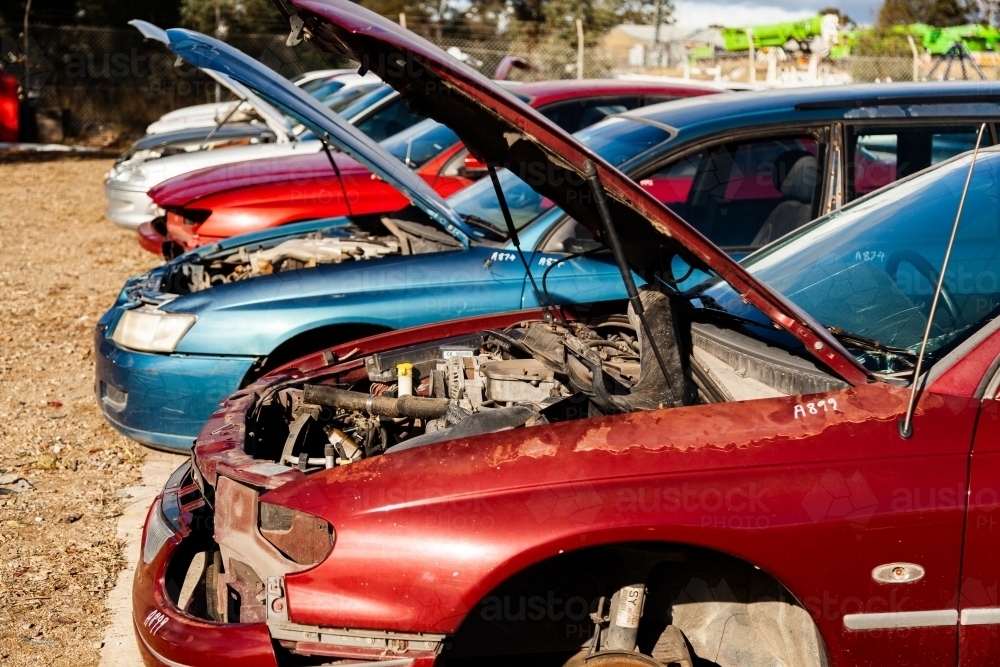 Wrecked and smashed cars parked in car wreckers junkyard - Australian Stock Image