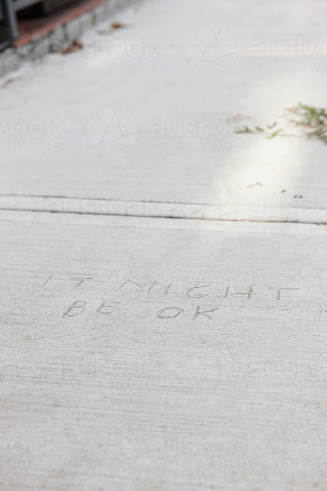 Written message in concrete pavement - Australian Stock Image