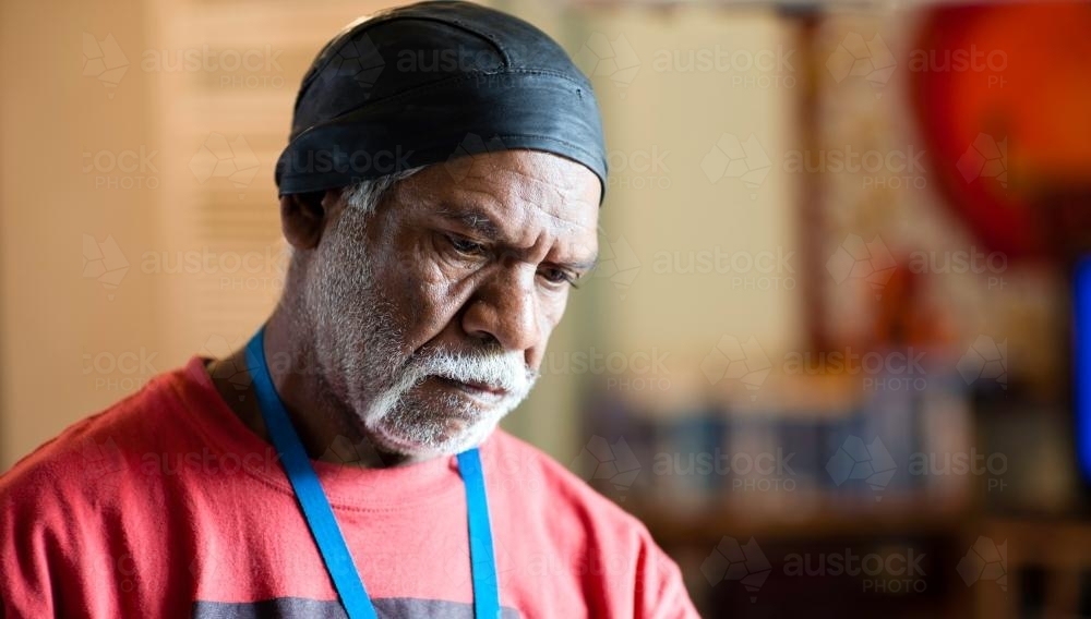 Wurundjeri Elder with Red Top Looking Downwards - Australian Stock Image