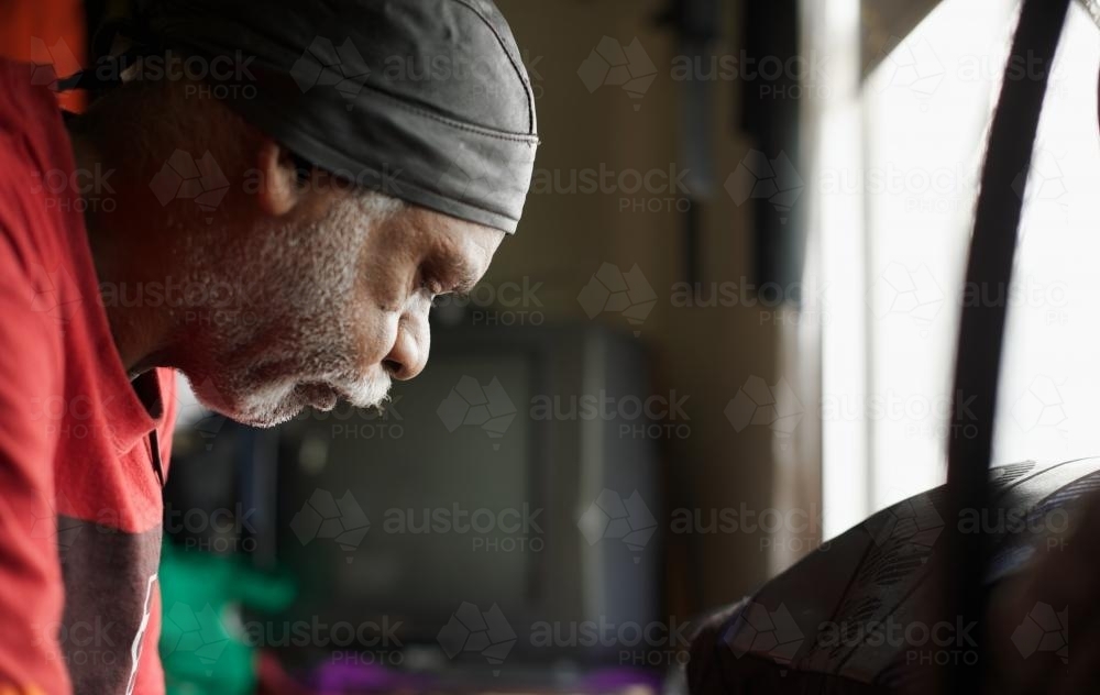 Wurundjeri Elder with Red Top near Window - Australian Stock Image