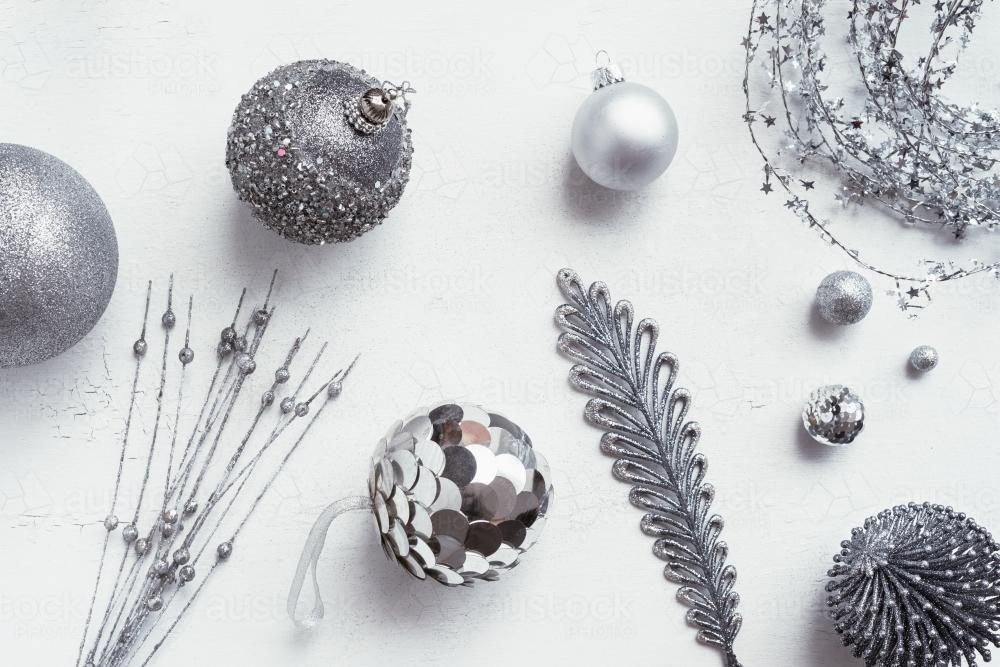 xmas silver ornaments on a white painted background - Australian Stock Image