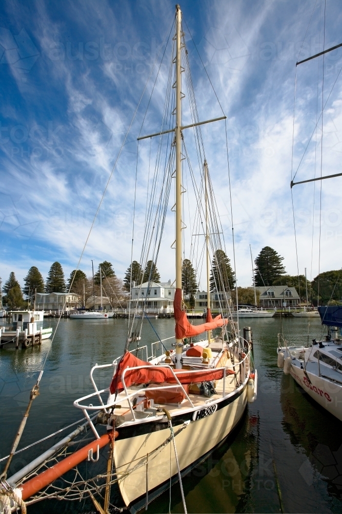 yacht moored in river at regional town - Australian Stock Image