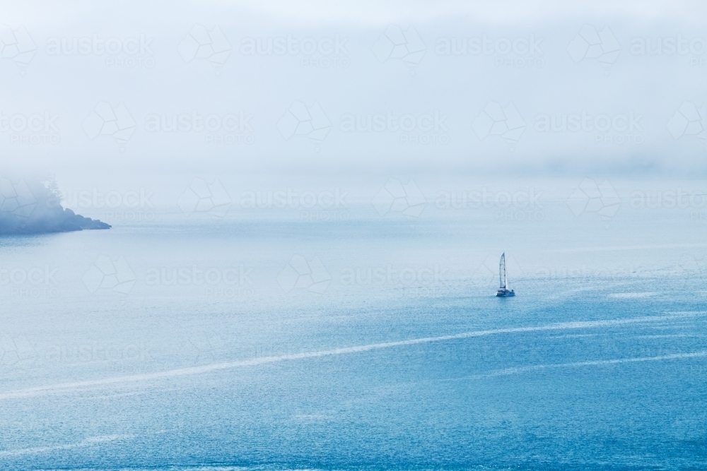 yacht sailing into sea fog - Australian Stock Image