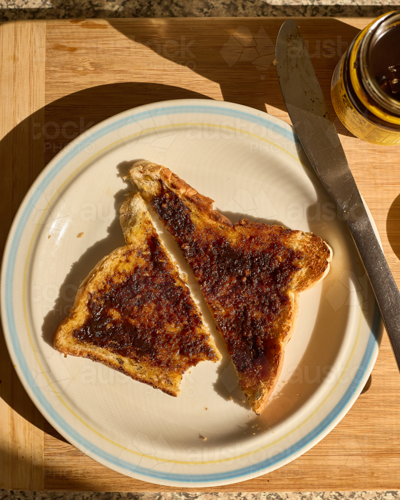 Yeast extract on toast with bite taken out - Australian Stock Image