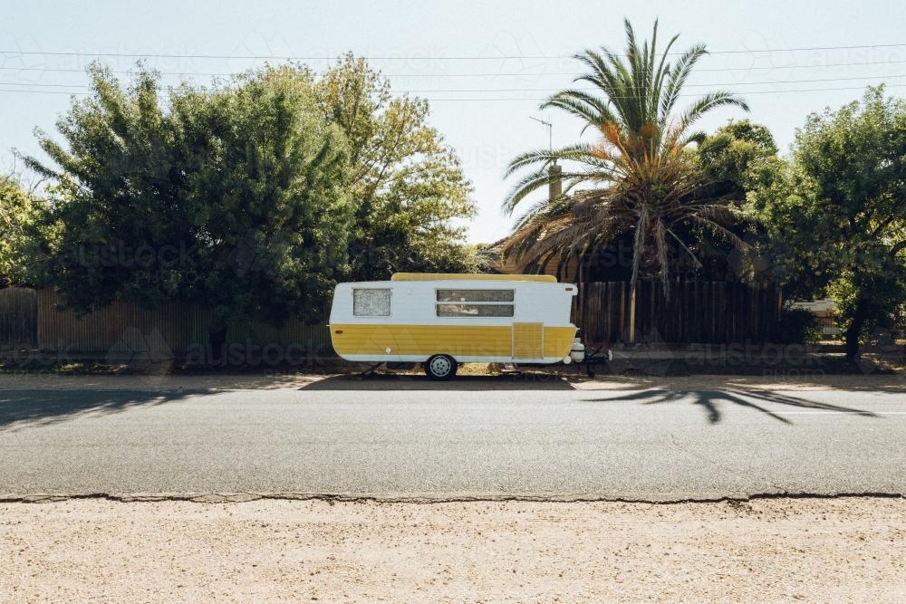 Yellow and white caravan parked in street - Australian Stock Image