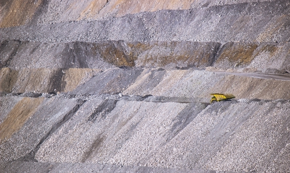 Yellow dump truck carting overburden in an open cut coal mine - Australian Stock Image