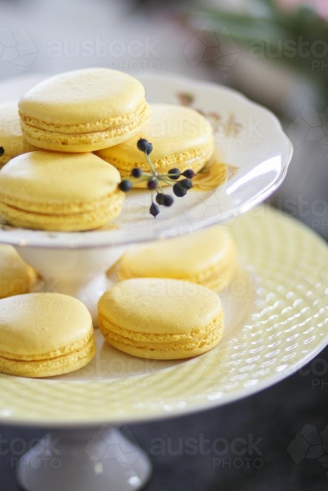 Yellow macarons on cake stand - Australian Stock Image
