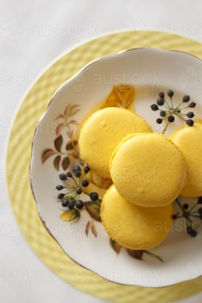 Yellow macarons on cake stand - Australian Stock Image