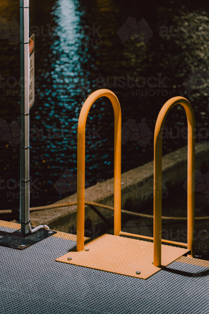 Yellow metal handrail at the dockside - Australian Stock Image