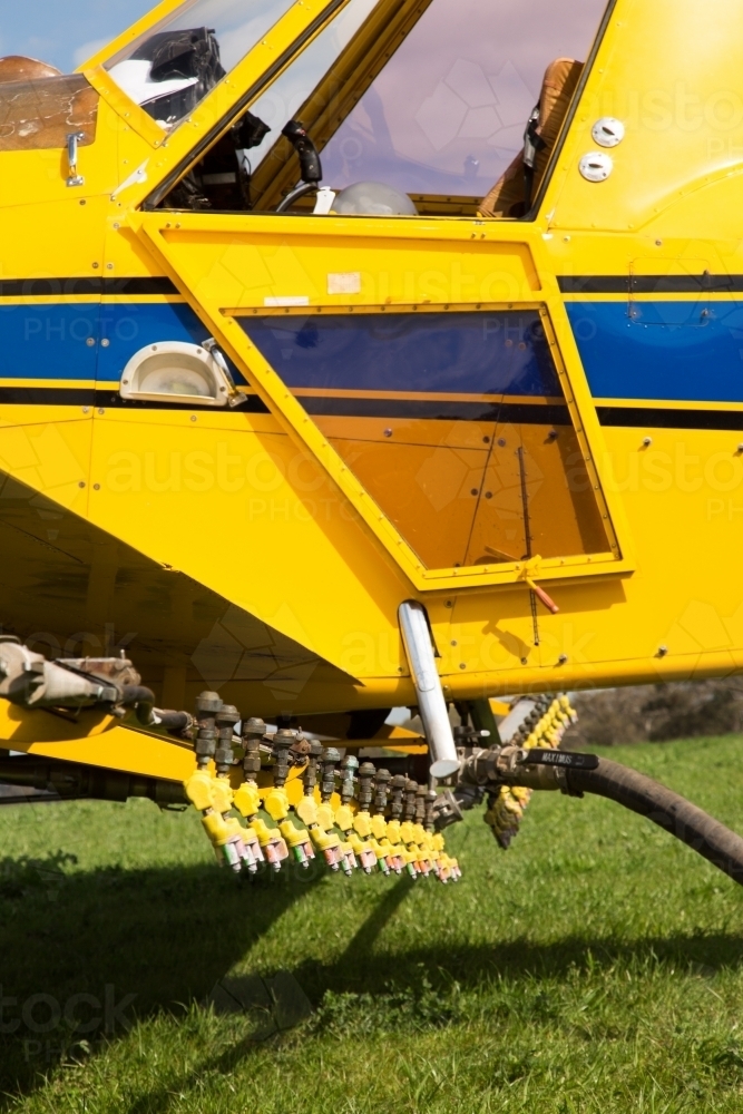 Image of Yellow plane refuelling and reloading - Austockphoto