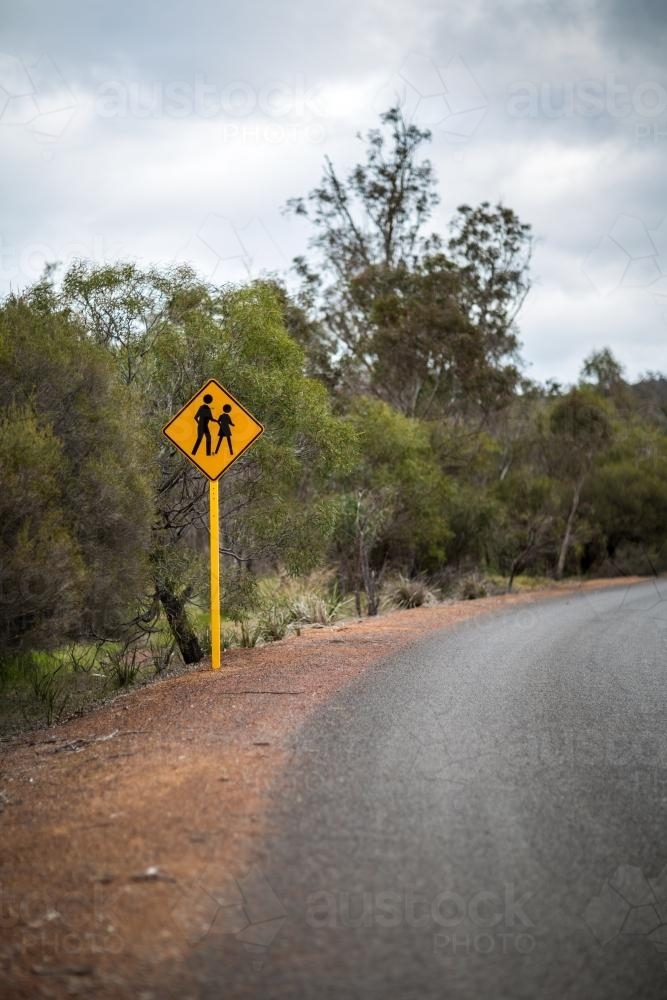Yellow sign for people crossing on country road - Australian Stock Image
