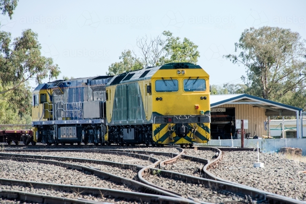 Image of Yellow train moving along the tracks in outback Australia ...