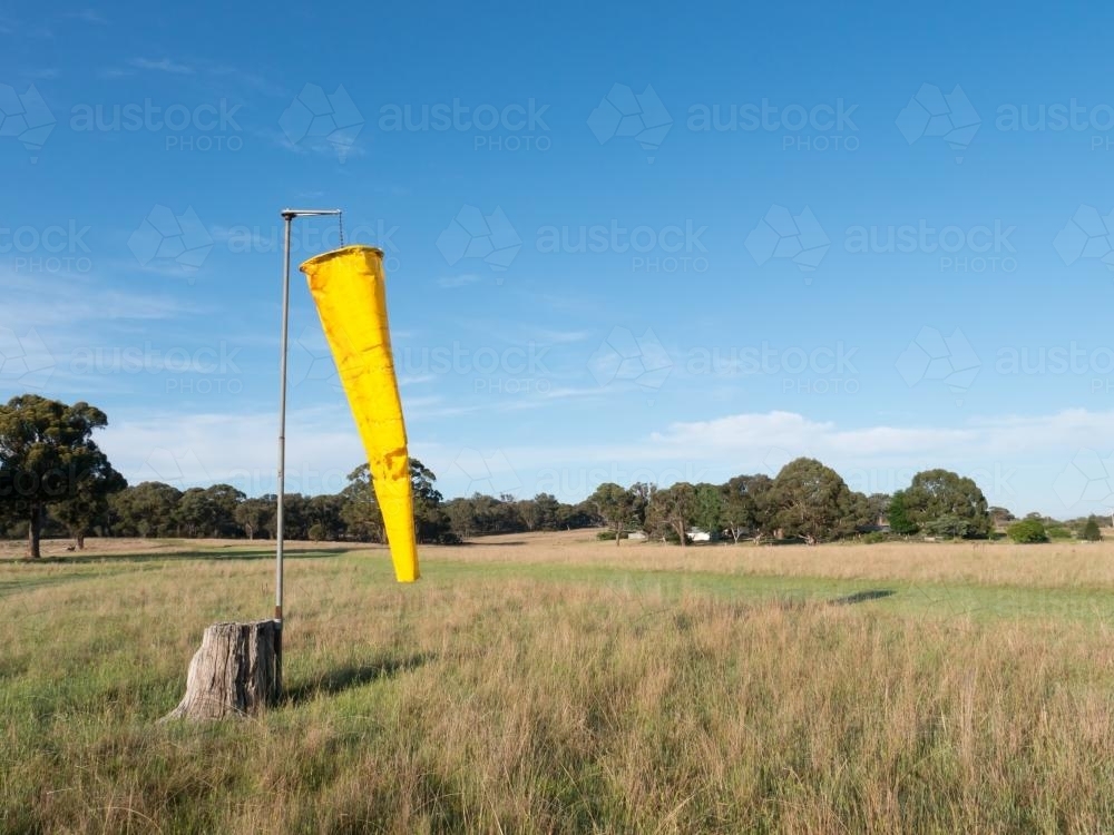 Yellow windsock on a country airstrip - Australian Stock Image