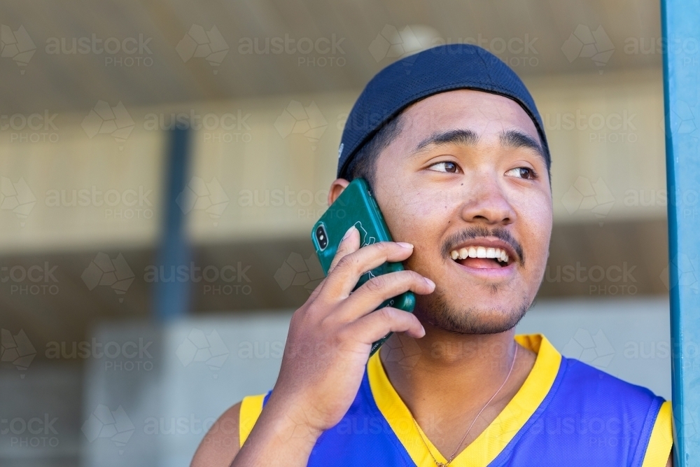 Young man talking on mobile phone - Australian Stock Image
