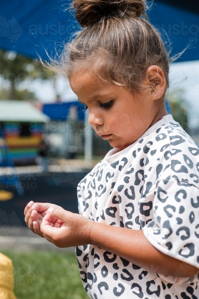 Young Aboriginal girl outside at preschool - Australian Stock Image