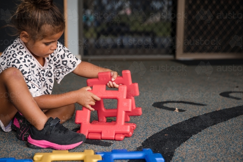 Young Aboriginal girl playing at preschool - Australian Stock Image