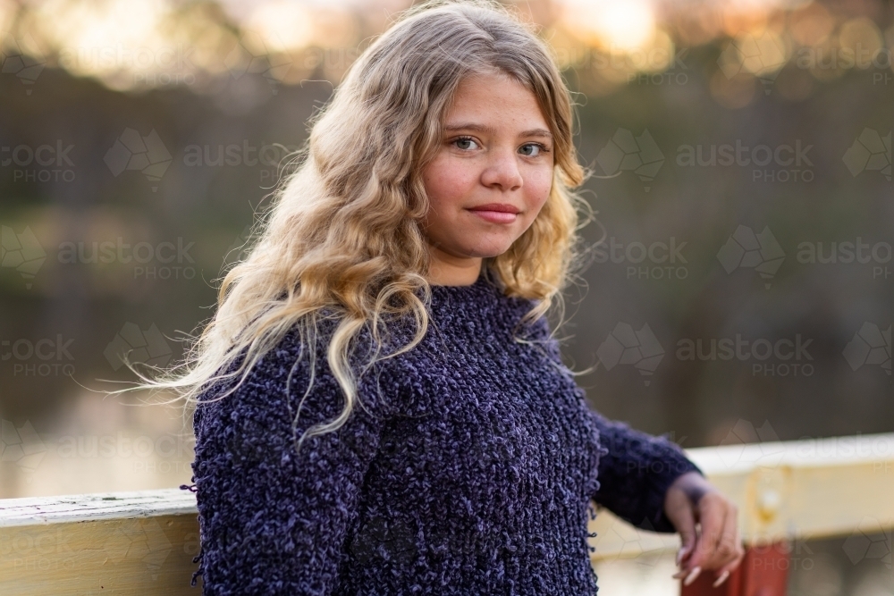 young aboriginal girl with blonde hair looking at camera - Australian Stock Image