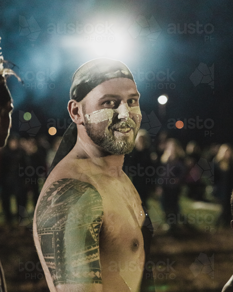 Young Aboriginal Male Smiling night portrait - Australian Stock Image