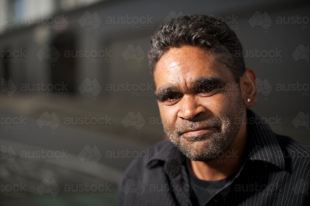 Young Aboriginal Man Looking at Camera - Australian Stock Image